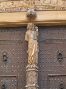 The Virgin Mary carved out of a ruin of a Roman column. Below her is Adam and Eve